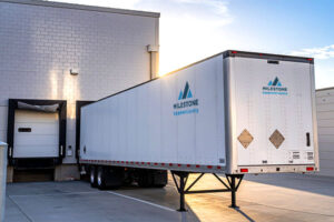 Milestone trailer backed into dock symbolizing tariff transportation impact