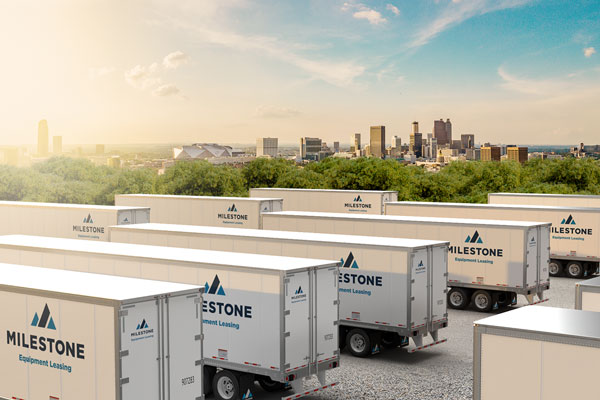 Milestone semi trailer rentals parked in Atlanta yard with skyline view