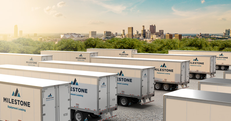 Fleet of Milestone semi trailers in Atlanta with skyline in background